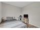 Bedroom with a full-size bed, TV, and small storage at 2103 Coronado N. Pkwy # D, Denver, CO 80229