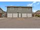 View of four garages with parking spaces in front at 2103 Coronado N. Pkwy # D, Denver, CO 80229