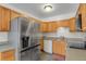 Kitchen with stainless steel appliances and wood cabinets at 2103 Coronado N. Pkwy # D, Denver, CO 80229