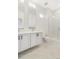 Modern bathroom with double vanity, glass shower, and marble-look floors at 5870 W 91St Ave, Westminster, CO 80031