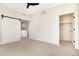 Bedroom with ceiling fan, sliding barn door, and walk-in closet at 5870 W 91St Ave, Westminster, CO 80031