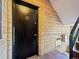 Building entry with a black door and brick facade at 1100 Colorado Blvd # 103, Denver, CO 80206