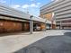 Covered parking with brick walls and a parking space at 1100 Colorado Blvd # 103, Denver, CO 80206