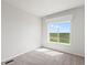 Bright bedroom with large window and carpet flooring at 165 S County Road 197, Byers, CO 80103