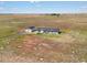 Aerial view of a house and detached garage on a large lot at 165 S County Road 197, Byers, CO 80103