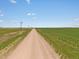 Long dirt road leading through open fields at 165 S County Road 197, Byers, CO 80103