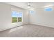 Spacious bedroom with carpeted floor, large window, and ceiling fan at 165 S County Road 197, Byers, CO 80103