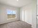 Bright bedroom with carpet flooring and a view at 165 S County Road 197, Byers, CO 80103