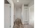 Bright hallway with wood-look flooring and built-in storage at 165 S County Road 197, Byers, CO 80103