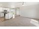 Spacious living room with carpeted floors and large window offering scenic views at 165 S County Road 197, Byers, CO 80103