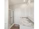 Main bathroom with double vanity, marble countertop, and shower at 165 S County Road 197, Byers, CO 80103