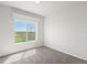 Spacious bedroom with large window and carpet at 165 S County Road 197, Byers, CO 80103