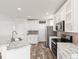 Modern kitchen with white cabinets, marble countertops, and stainless steel appliances at 165 S County Road 197, Byers, CO 80103