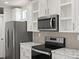 Stainless steel appliances and white cabinets at 165 S County Road 197, Byers, CO 80103