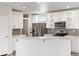 Bright kitchen featuring white cabinets, marble countertops, and stainless steel appliances at 165 S County Road 197, Byers, CO 80103