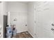 Laundry room with shelving and vinyl flooring at 165 S County Road 197, Byers, CO 80103