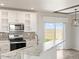 Modern kitchen with white cabinets, marble countertops, and stainless steel appliances at 165 S County Road 197, Byers, CO 80103