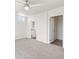 Large main bedroom with carpeted floor, ceiling fan, and ensuite bathroom at 165 S County Road 197, Byers, CO 80103