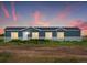 Ranch style home with blue exterior, and landscaped yard at 165 S County Road 197, Byers, CO 80103