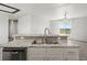 Kitchen island with double sink and dishwasher at 165 S County Road 197, Byers, CO 80103