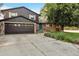 Two-story home with a landscaped yard and attached garage at 213 23Rd Ave, Longmont, CO 80501