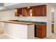 Basement wet bar with wood cabinets and granite top at 19815 W Top O The Moor Dr, Monument, CO 80132