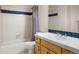 Basement bathroom with tub, shower and wood cabinet at 19815 W Top O The Moor Dr, Monument, CO 80132