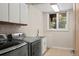 Laundry room with washer, dryer, sink, and cabinets at 19815 W Top O The Moor Dr, Monument, CO 80132