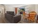 Living room features gray sectional sofa and wood dining set at 1599 W Beekman Pl Pl, Denver, CO 80221