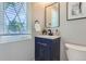 Stylish bathroom with a navy vanity and a large window at 1649 S Ivory Cir # D, Aurora, CO 80017