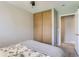 Bedroom with double doors to closet and access to hallway at 1649 S Ivory Cir # D, Aurora, CO 80017