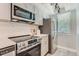 Updated kitchen with stainless steel appliances and white subway tile at 1649 S Ivory Cir # D, Aurora, CO 80017