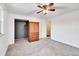 Spacious bedroom with grey carpet, ceiling fan and large closet at 5667 S Lowell Blvd, Littleton, CO 80123