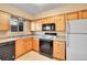 Kitchen features light wood cabinets and modern appliances at 5667 S Lowell Blvd, Littleton, CO 80123