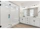 Modern bathroom with glass shower, dual vanity, and white cabinets at 4711 Twelve Oaks Way, Castle Rock, CO 80104