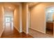 Hallway with wood flooring, carpet, and views into other rooms at 9567 Dahlia Ln, Thornton, CO 80229