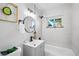 Clean bathroom with gray tile, bathtub, and vanity at 2996 S Sheridan Blvd, Denver, CO 80227