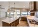Modern kitchen featuring an island, stainless steel appliances, and hardwood floors at 37057 Still Rock Pt, Elizabeth, CO 80107
