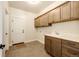 Laundry room with cabinets and utility sink at 37057 Still Rock Pt, Elizabeth, CO 80107