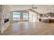 Open concept living area with hardwood floors and stone fireplace at 37057 Still Rock Pt, Elizabeth, CO 80107