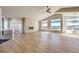 Spacious living room with hardwood floors, stone fireplace, and large windows at 37057 Still Rock Pt, Elizabeth, CO 80107