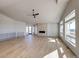 Living room with hardwood floors, stone fireplace, and large windows at 37057 Still Rock Pt, Elizabeth, CO 80107