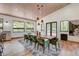 Bright dining room with large windows and a rustic wood table at 133 Adams Way, Breckenridge, CO 80424