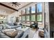 Relaxing living room with a brick fireplace and floor to ceiling windows at 133 Adams Way, Breckenridge, CO 80424