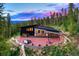 Aerial view of modern home with large patio and mountain views at 133 Adams Way, Breckenridge, CO 80424