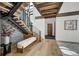 Elegant entryway with modern staircase, wood floors, and bench at 72 Dyer Trl, Breckenridge, CO 80424