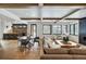 Spacious living room with wood beams, fireplace, and large windows at 72 Dyer Trl, Breckenridge, CO 80424