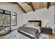 Luxurious primary suite with a king-size bed and large windows at 72 Dyer Trl, Breckenridge, CO 80424
