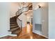 Elegant entryway with hardwood floors and a curved staircase at 7892 S Country Club Pkwy, Aurora, CO 80016