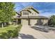 Two-story house with stone accents, two-car garage, and landscaped lawn at 7892 S Country Club Pkwy, Aurora, CO 80016